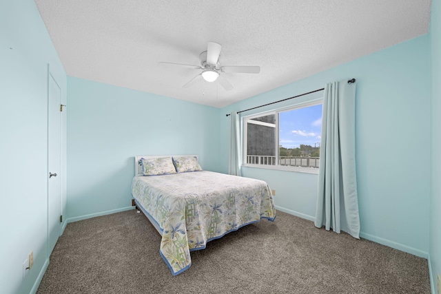 bedroom with a ceiling fan, a textured ceiling, baseboards, and carpet flooring