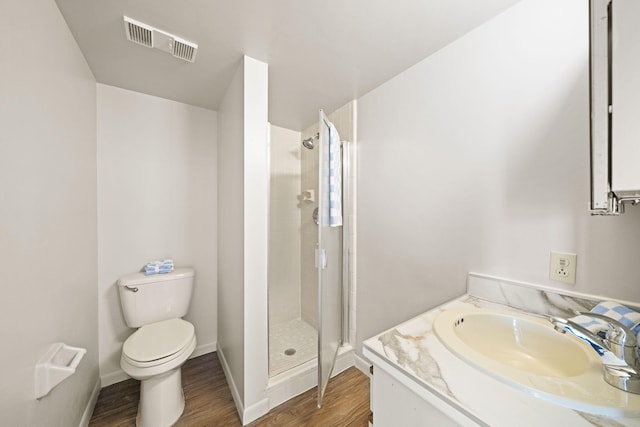 full bathroom featuring baseboards, visible vents, toilet, wood finished floors, and a shower stall