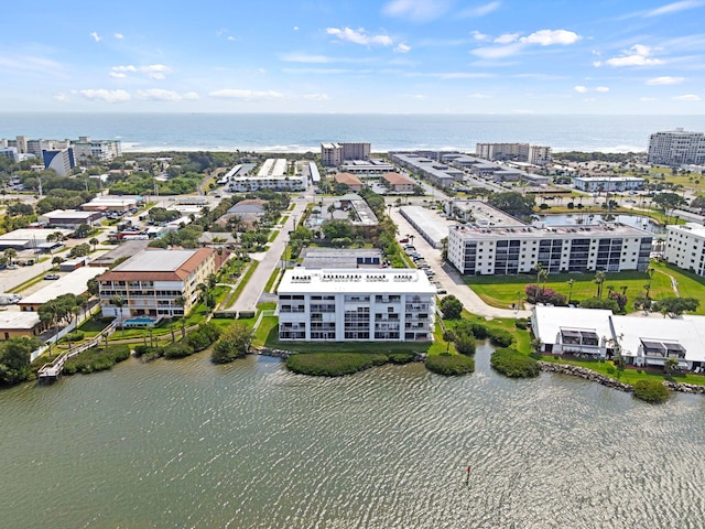 birds eye view of property with a water view and a city view