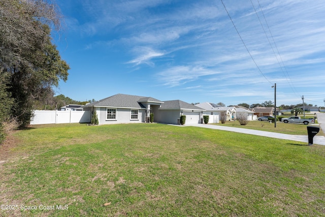 view of front facade featuring stucco siding, concrete driveway, an attached garage, fence, and a front lawn