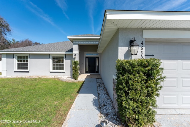 doorway to property featuring an attached garage, stucco siding, a shingled roof, and a yard