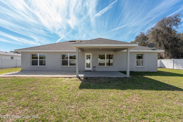 back of property featuring a patio area, a fenced backyard, a lawn, and stucco siding