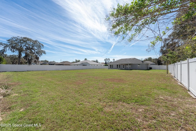 view of yard with a fenced backyard