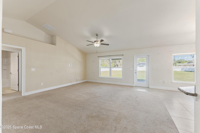 unfurnished living room featuring lofted ceiling, ceiling fan, baseboards, and light colored carpet