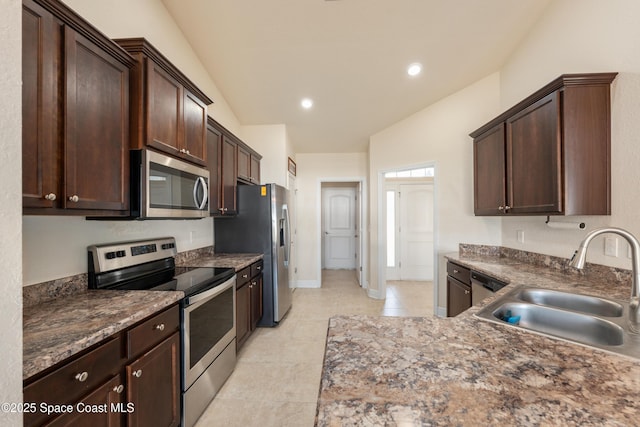 kitchen with light tile patterned floors, stainless steel appliances, recessed lighting, a sink, and dark brown cabinetry