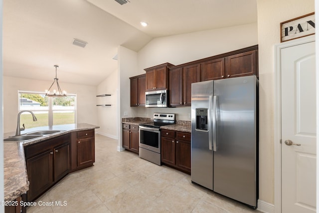 kitchen featuring visible vents, appliances with stainless steel finishes, hanging light fixtures, dark brown cabinets, and a sink