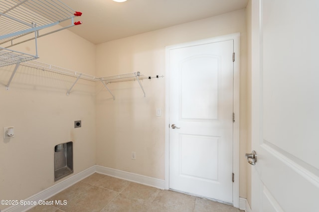 laundry room featuring laundry area, light tile patterned floors, baseboards, and hookup for an electric dryer