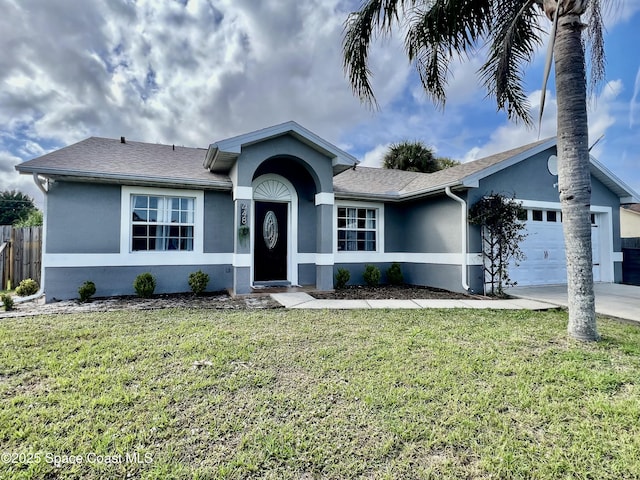 ranch-style home featuring a front yard, an attached garage, fence, and stucco siding