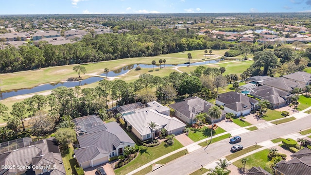 bird's eye view featuring golf course view, a water view, and a residential view