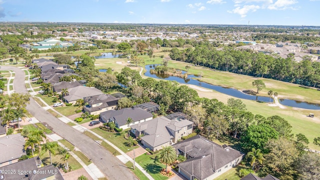 bird's eye view with a water view, a residential view, and golf course view