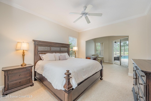 bedroom featuring access to outside, multiple windows, ornamental molding, and light colored carpet