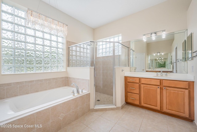 full bath with a garden tub, a shower stall, vanity, and tile patterned floors