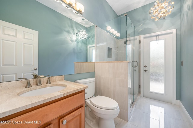 bathroom featuring toilet, tile patterned floors, a shower stall, and vanity