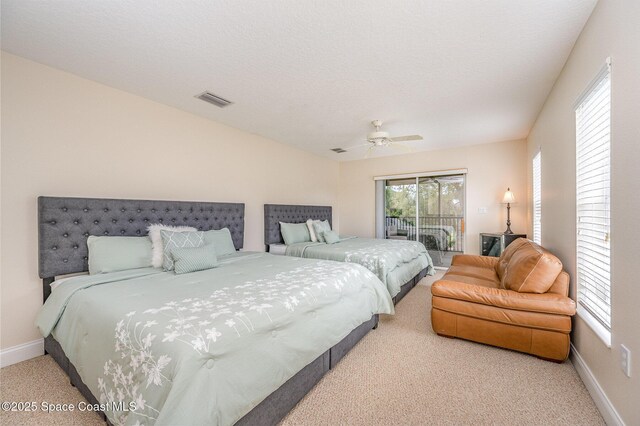 carpeted bedroom featuring a textured ceiling, a ceiling fan, baseboards, visible vents, and access to exterior