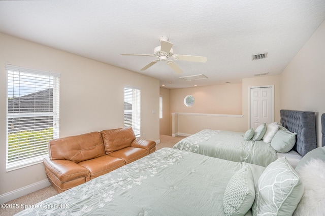 bedroom featuring visible vents, light carpet, and multiple windows