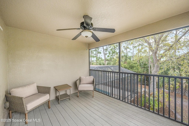 sunroom / solarium featuring ceiling fan