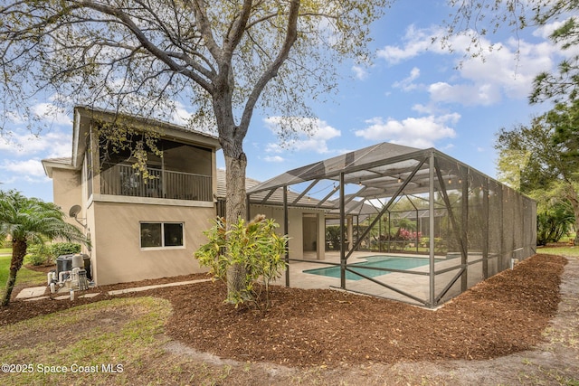 outdoor pool with a patio and a lanai