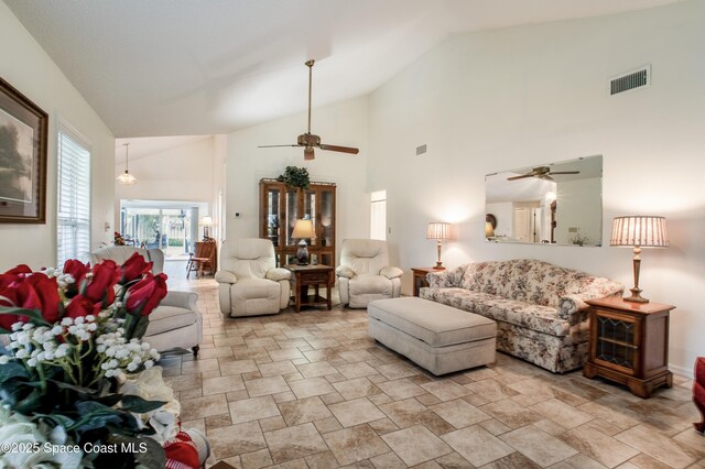 living area with high vaulted ceiling, visible vents, and ceiling fan