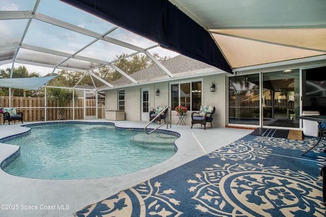 view of pool featuring a patio area, fence, a fenced in pool, and a lanai