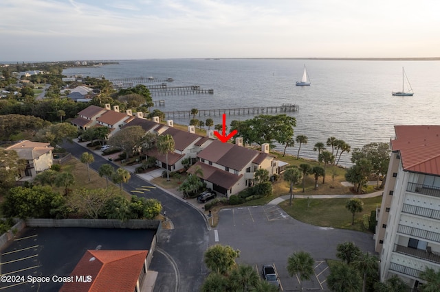 drone / aerial view featuring a water view and a residential view