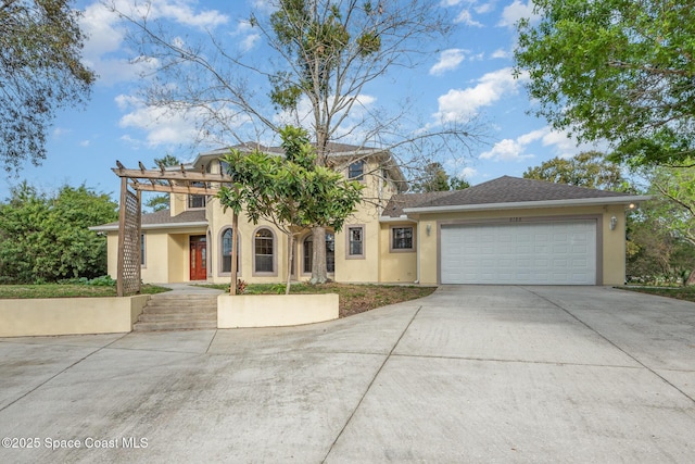 view of front facade with driveway, a garage, and stucco siding