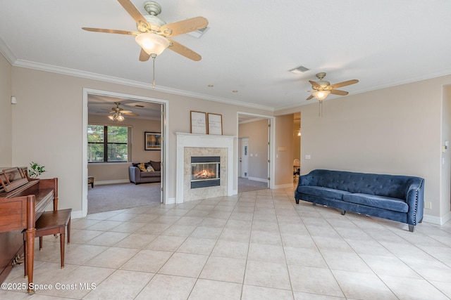 living room featuring ornamental molding, light tile patterned flooring, a tile fireplace, and visible vents