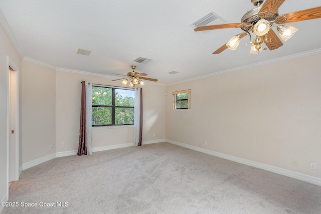 spare room with baseboards, ornamental molding, visible vents, and light colored carpet