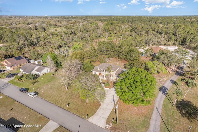 bird's eye view with a wooded view