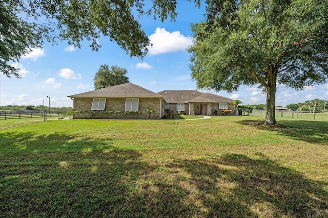 single story home with a front yard and fence