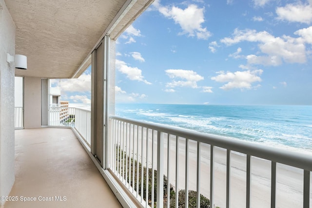 balcony with a view of the beach and a water view