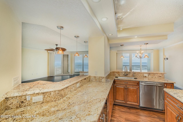 kitchen featuring a sink, light stone countertops, dishwasher, brown cabinetry, and dark wood-style flooring