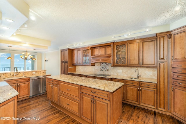 kitchen with a sink, black electric stovetop, dishwasher, and brown cabinetry