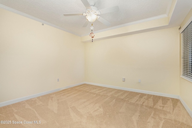 unfurnished room with light carpet, a textured ceiling, and crown molding