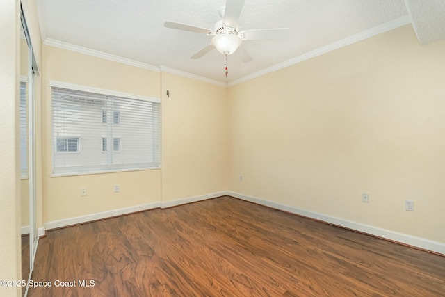 unfurnished room featuring a ceiling fan, a textured ceiling, dark wood finished floors, crown molding, and baseboards