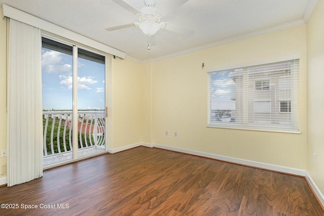 unfurnished room featuring ceiling fan, baseboards, wood finished floors, and crown molding