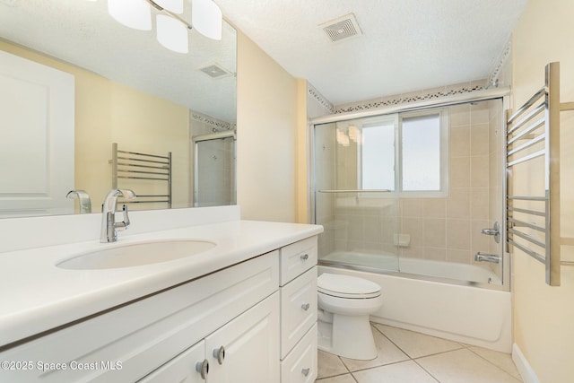 bathroom with tile patterned floors, visible vents, a textured ceiling, and toilet