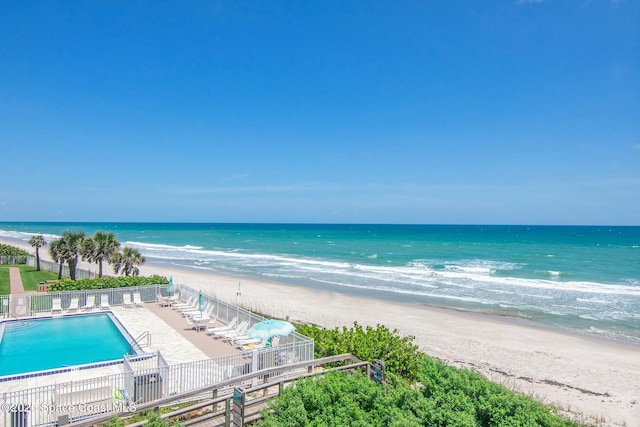 view of water feature with a view of the beach and fence