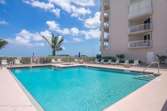 community pool featuring a patio area and fence