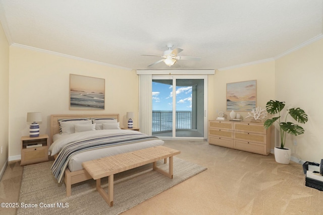 carpeted bedroom featuring baseboards, access to exterior, a ceiling fan, and ornamental molding