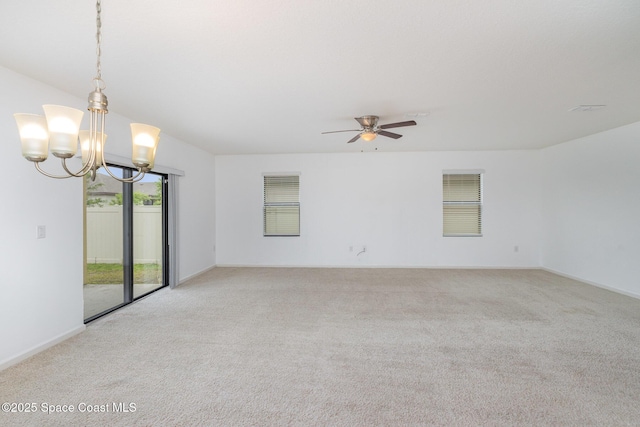 unfurnished room with light carpet, a chandelier, and a ceiling fan