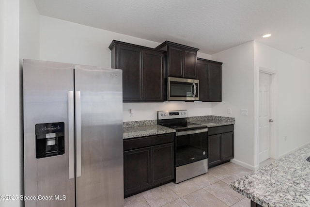kitchen featuring stainless steel appliances, light tile patterned flooring, recessed lighting, and baseboards
