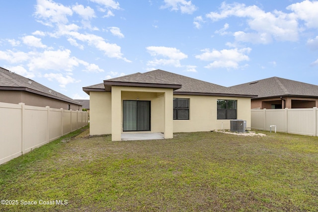 back of property with central AC, stucco siding, and roof with shingles