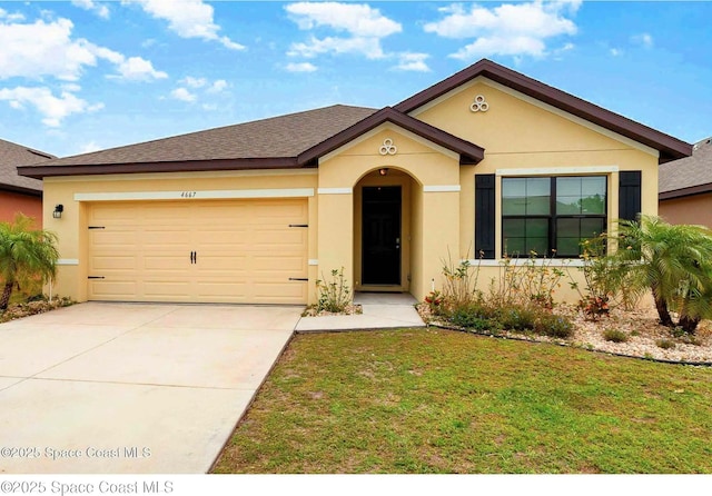 view of front of home with stucco siding, a front yard, driveway, and a garage