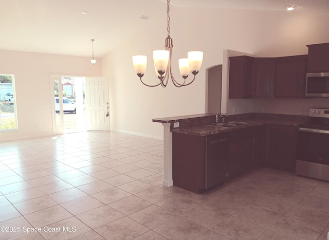 kitchen featuring light tile patterned floors, stainless steel appliances, a peninsula, a sink, and vaulted ceiling