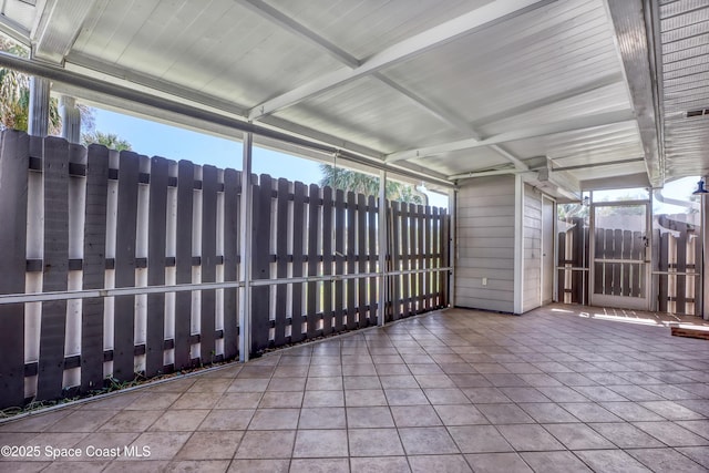 unfurnished sunroom with beamed ceiling