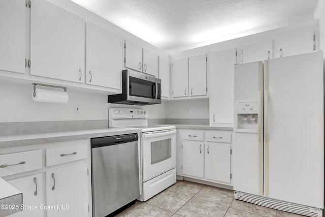 kitchen featuring a textured ceiling, stainless steel appliances, light countertops, and white cabinets