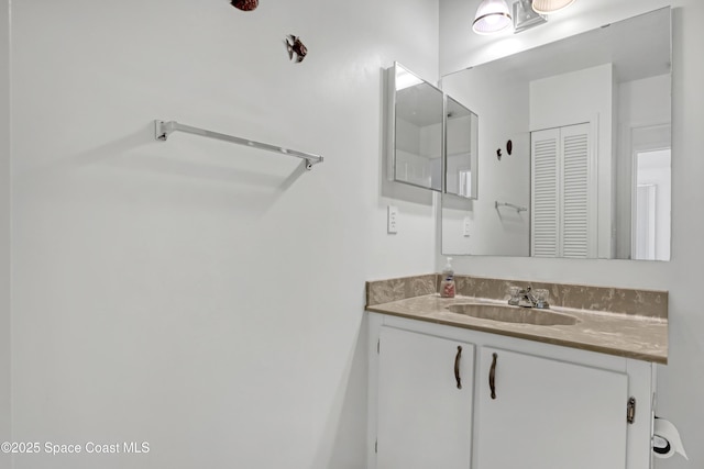 bathroom with a closet and vanity