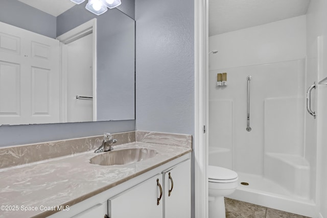 full bathroom with a shower, vanity, and toilet