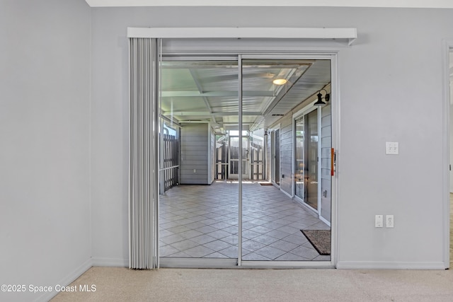 interior space with baseboards and tile patterned floors