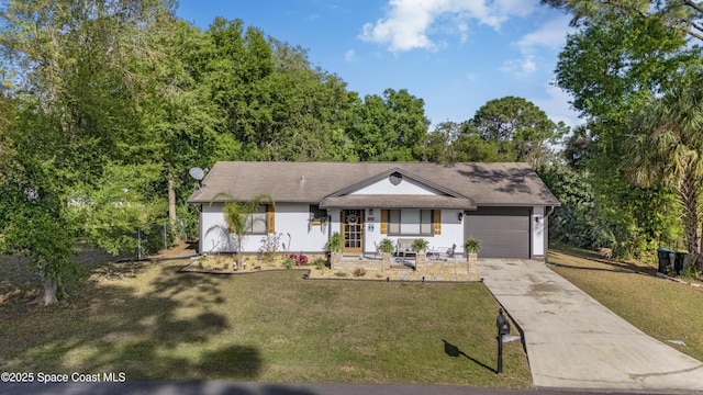 ranch-style home with a front lawn, a garage, and driveway